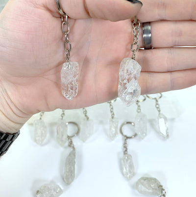 Crackle Quartz Keychains in a hand for size reference