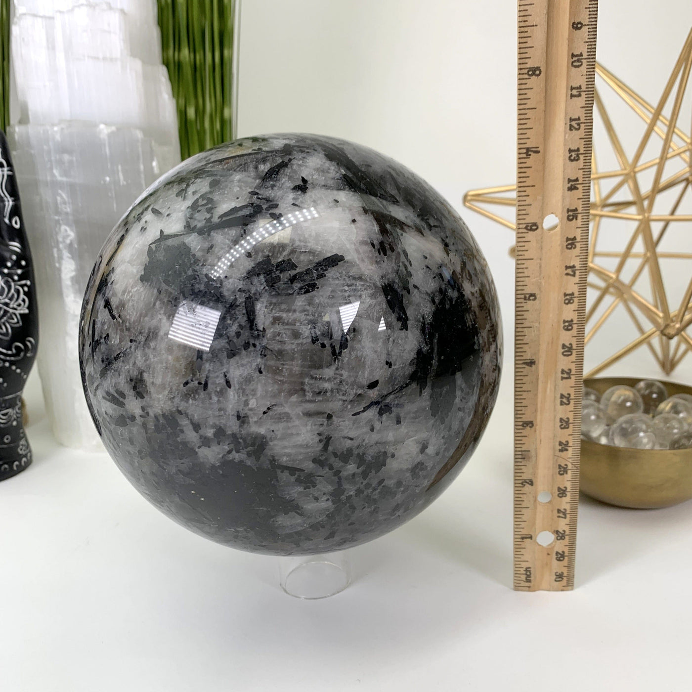 Picture of sphere next to ruler for size reference.