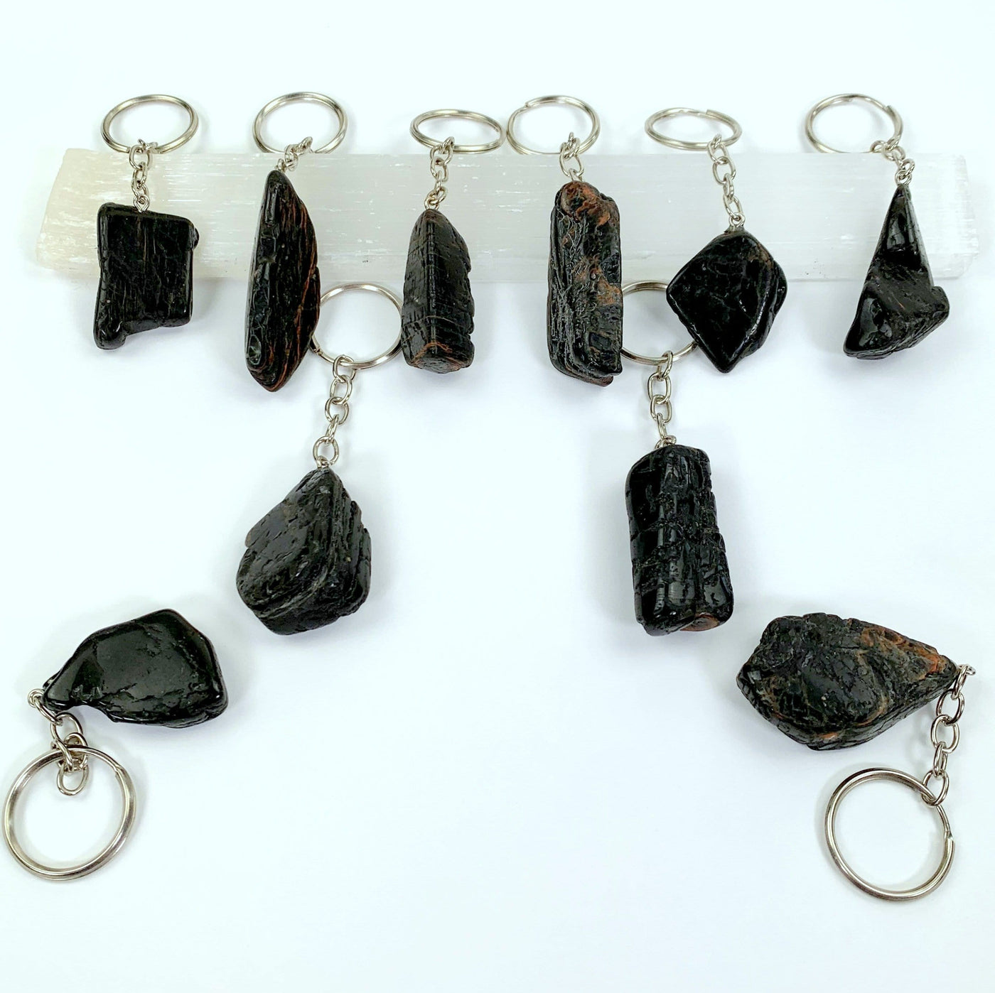 tourmaline with hematite keychains spread on a table