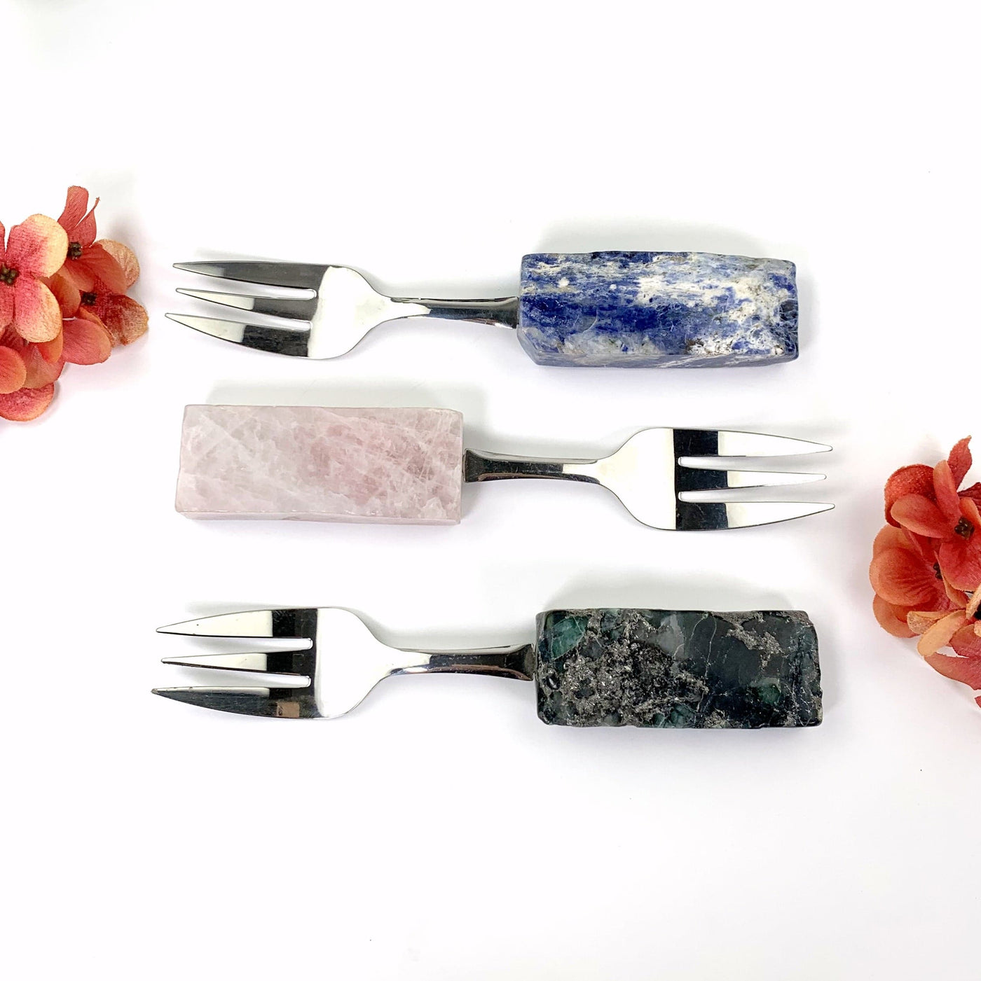 ALL 3 FORKS LAYING DOWN ON WHITE BACKGROUND FACE UP