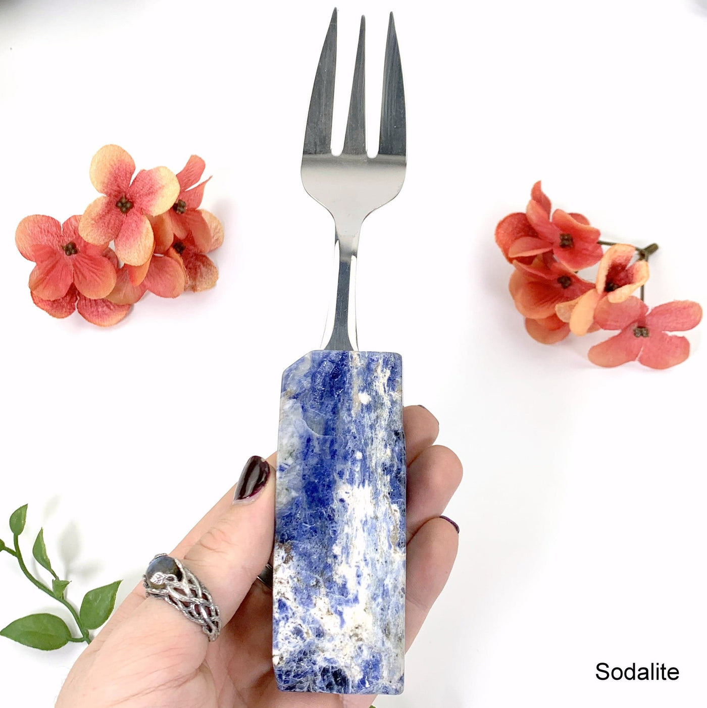 sodalite fork in hand with white background