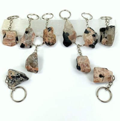  various Polished Tourmaline with Feldspar Keychains displayed to show various sizes colors shapes characteristics