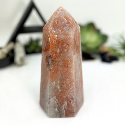 hematite quartz polished tower point show with a white background
