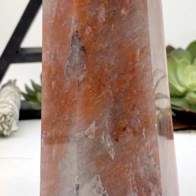 close up of the natural hematite quartz polished tower point show with a white background
