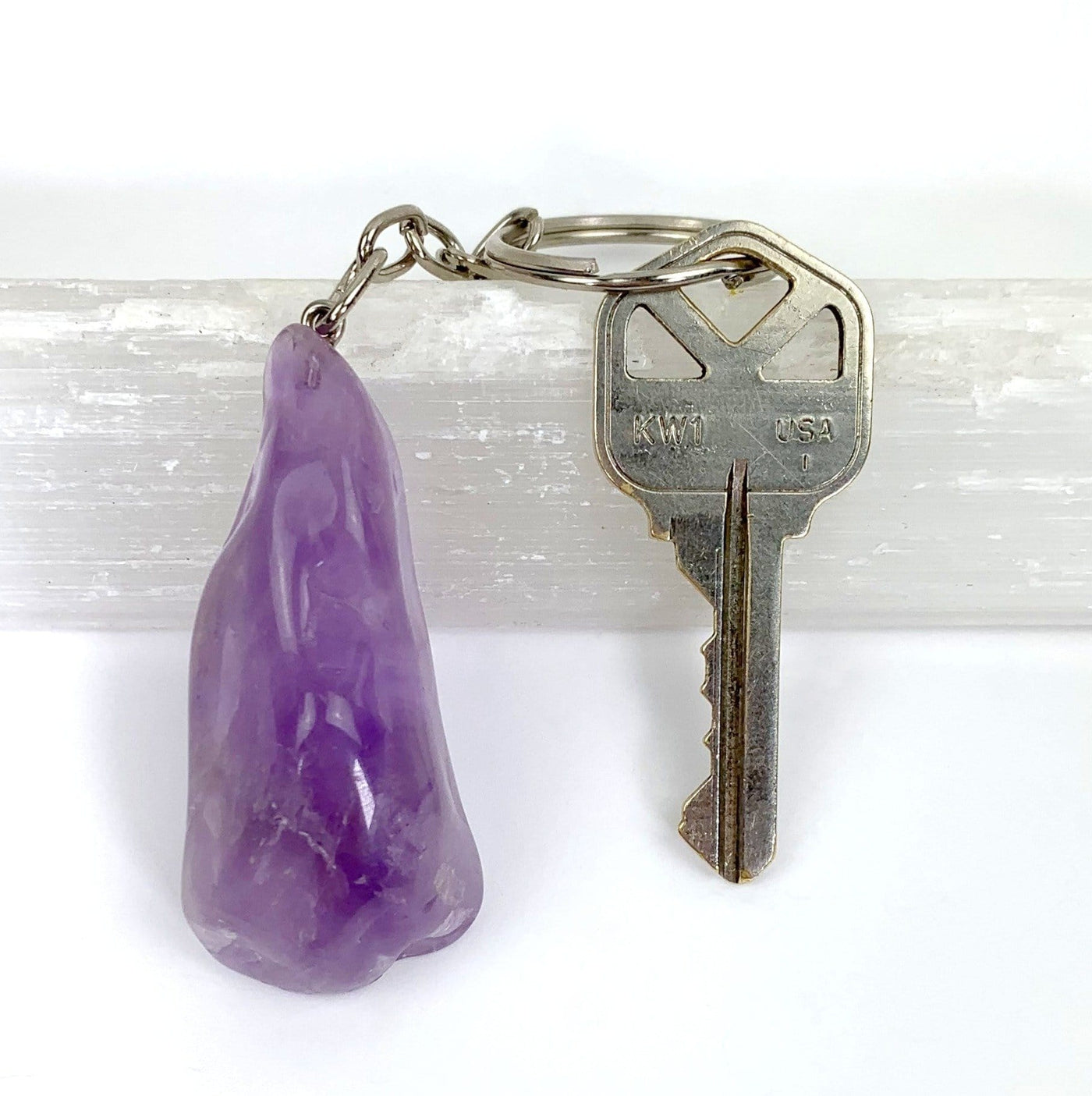 polished amethyst keychain attached to key on the ring hoop for size reference