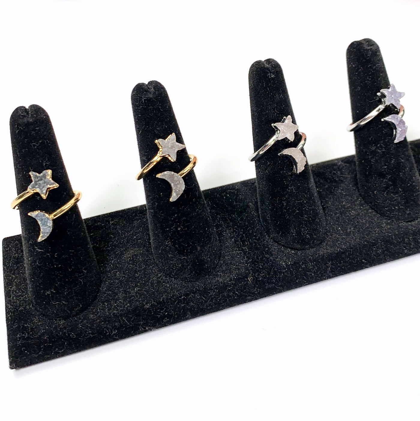 4 rings on black ring holders with white background
