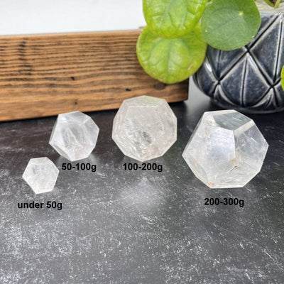 multiple crystal quartz dodecahedron shaped stones next to their weight in grams 