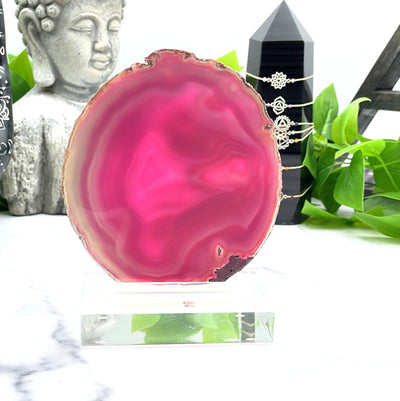 A beautiful Pink Dyed Agate on Acrylic stand with white background