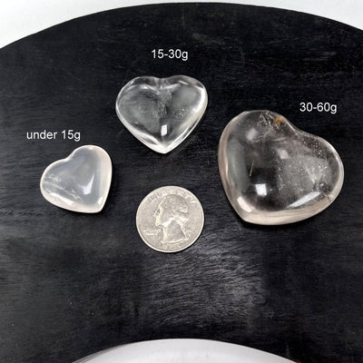 crystal quartz hearts next to a quarter for size reference 