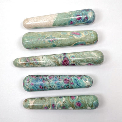 multiple ruby fuchsite massage wands displaying the different sizes and color patterns
