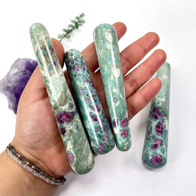ruby fuchsite massage wands in hand for size reference 