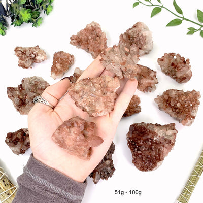 51 gram to 100 gram lithium quartz clusters 3 pieces fit in the palm of a man's hand