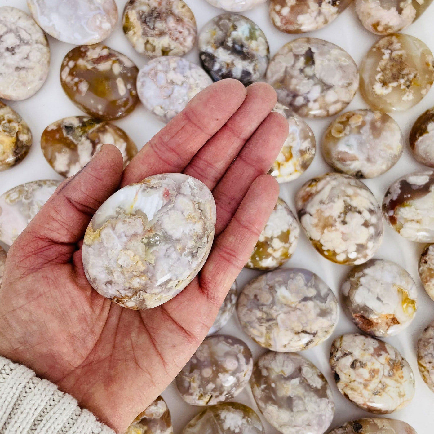 Flower Agate Polished Palm Stone on hand.