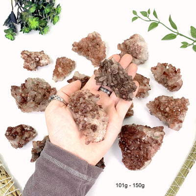 101 gram to 150 gram lithium quartz clusters 2 pieces fit in the palm of a man's hand