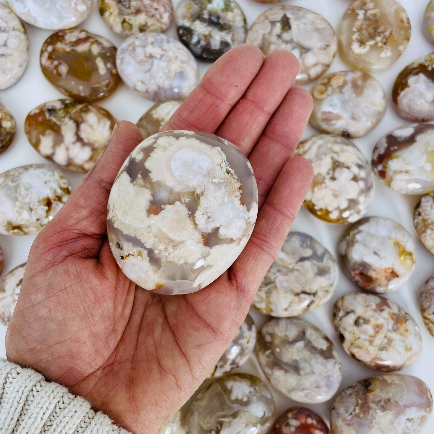 Flower Agate Polished Palm Stone on hand.