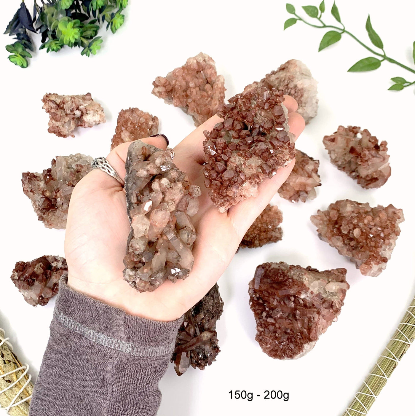150 gram to 200 gram lithium quartz clusters 2 pieces fit in the palm of a man's hand