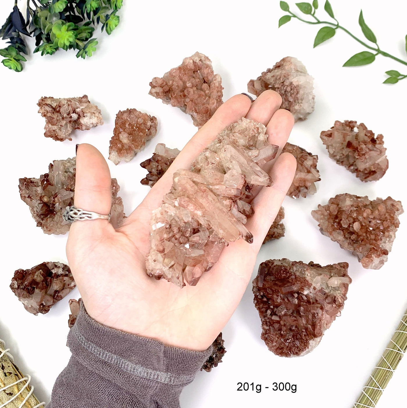 201 gram to 300 gram lithium quartz clusters 1 piece fits in the palm of a man's hand