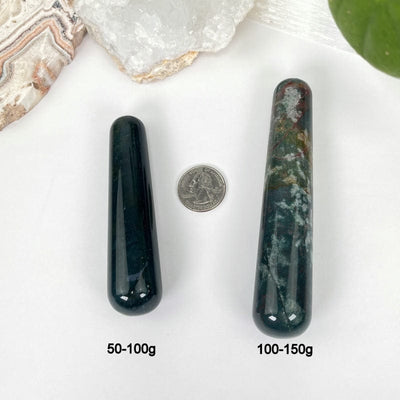 bloodstone massage wands next to a quarter and their weight in grams for size refence 