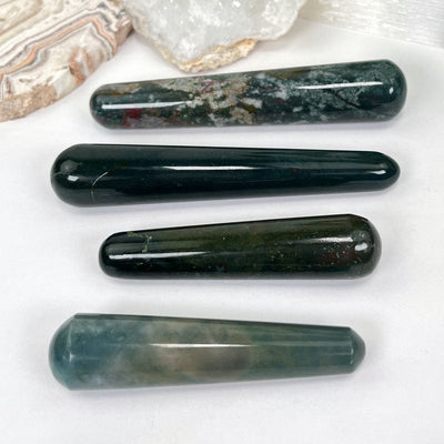 side shot of multiple bloodstone massage wands displaying the different thicknesses 