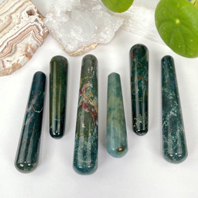 multiple bloodstone massage wands displaying the different greens, blues, tans, and spots of red