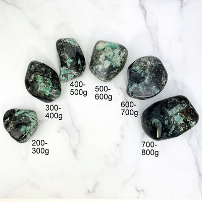 Emerald Freeform Tumbled Polished Stone line up showing the grams that we have available staring 200 to 800g