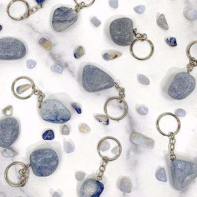 Tumbled Blue Quartz Keychains scattered on white background