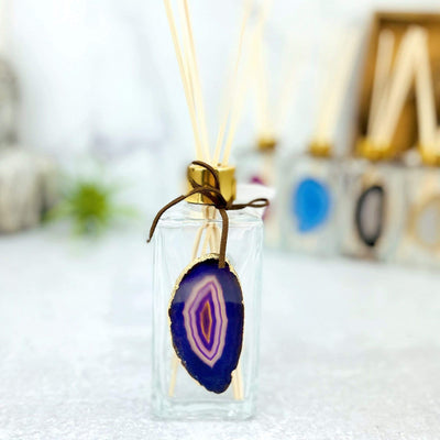 Picture of our purple agate slice diffuser, being displayed on a white back ground. 