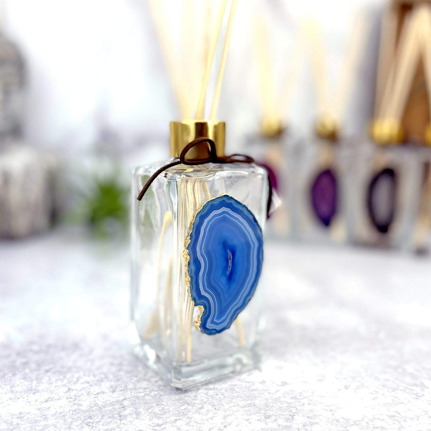 Picture of our blue agate slice diffuser, being displayed on a white back ground.