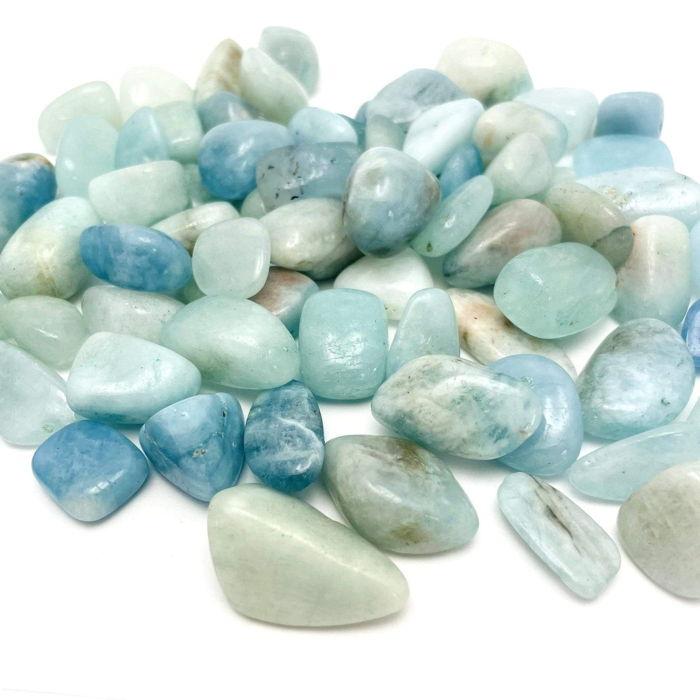 pile of Aquamarine Tumbled Stones Nuggets on white background