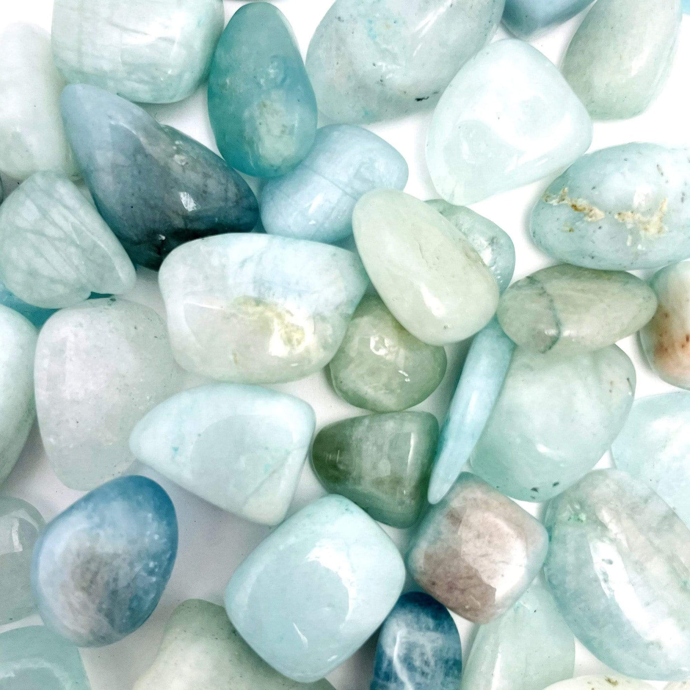Aquamarine Tumbled Stones Nuggets scattered across white background