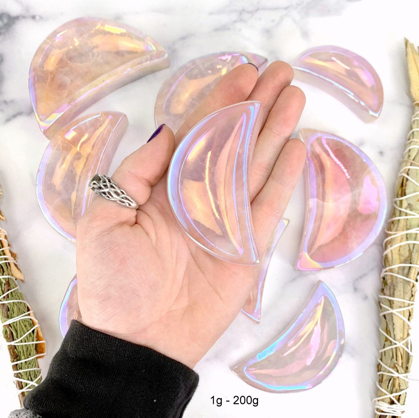 one 1gram - 200gram angel aura moon bowl in hand with marble background for size reference