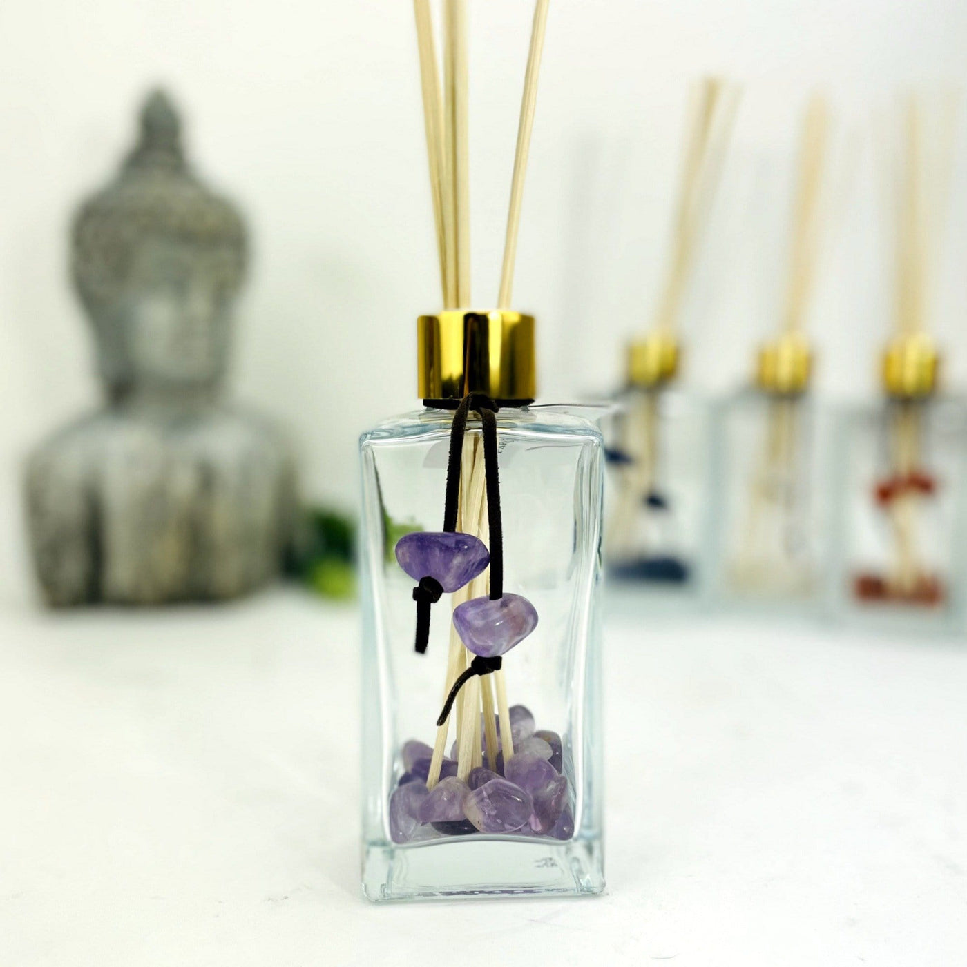 Tumbled Stone Diffuser Bottle--front view shot of glass bottle with amethyst stone on string.