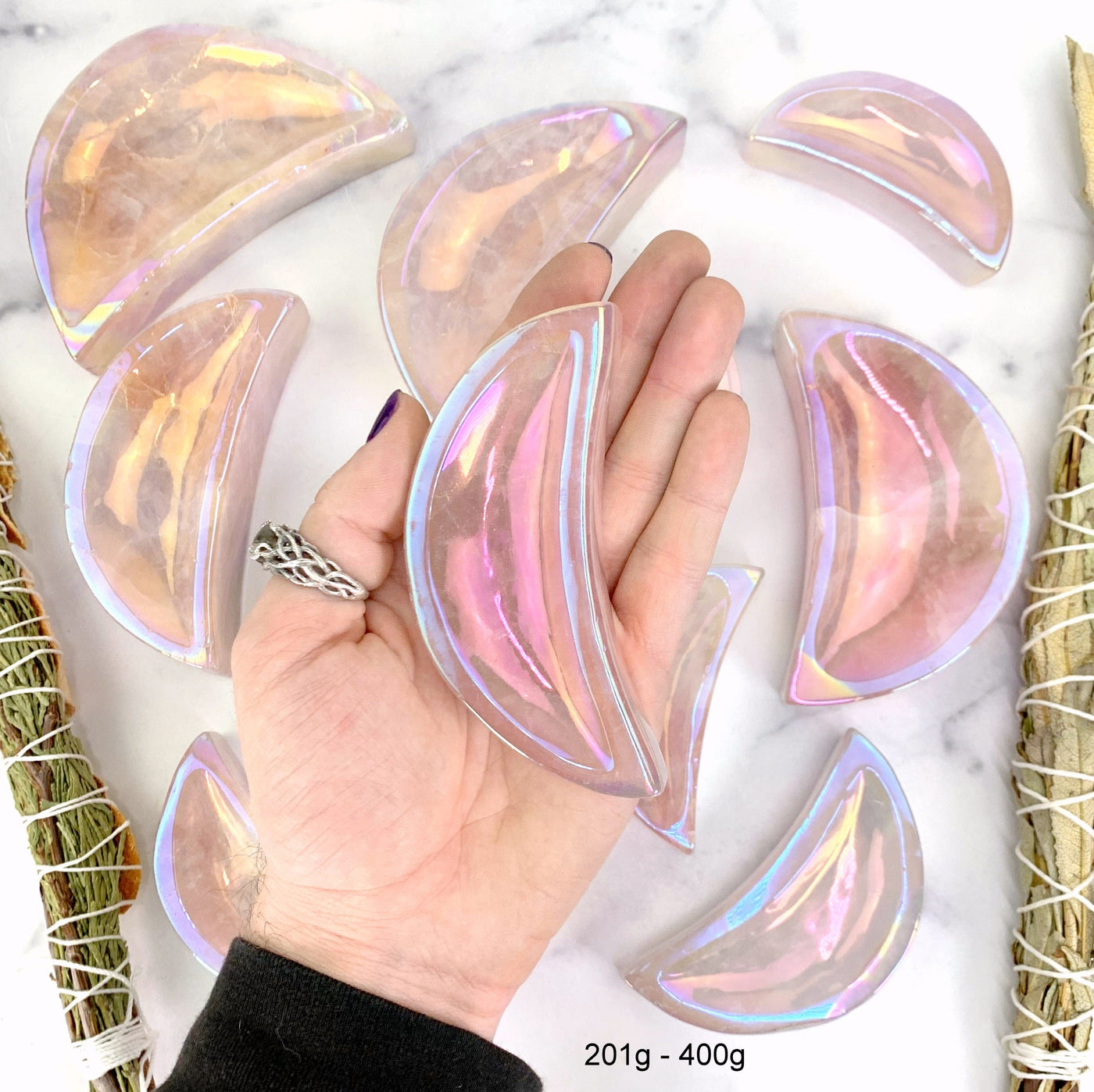 one 201gram - 400gram angel aura moon bowl in hand with marble background for size reference