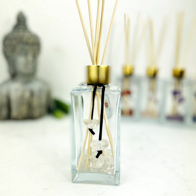 Tumbled Stone Diffuser Bottle--front view shot of glass bottle with crystal quartz stone on string.