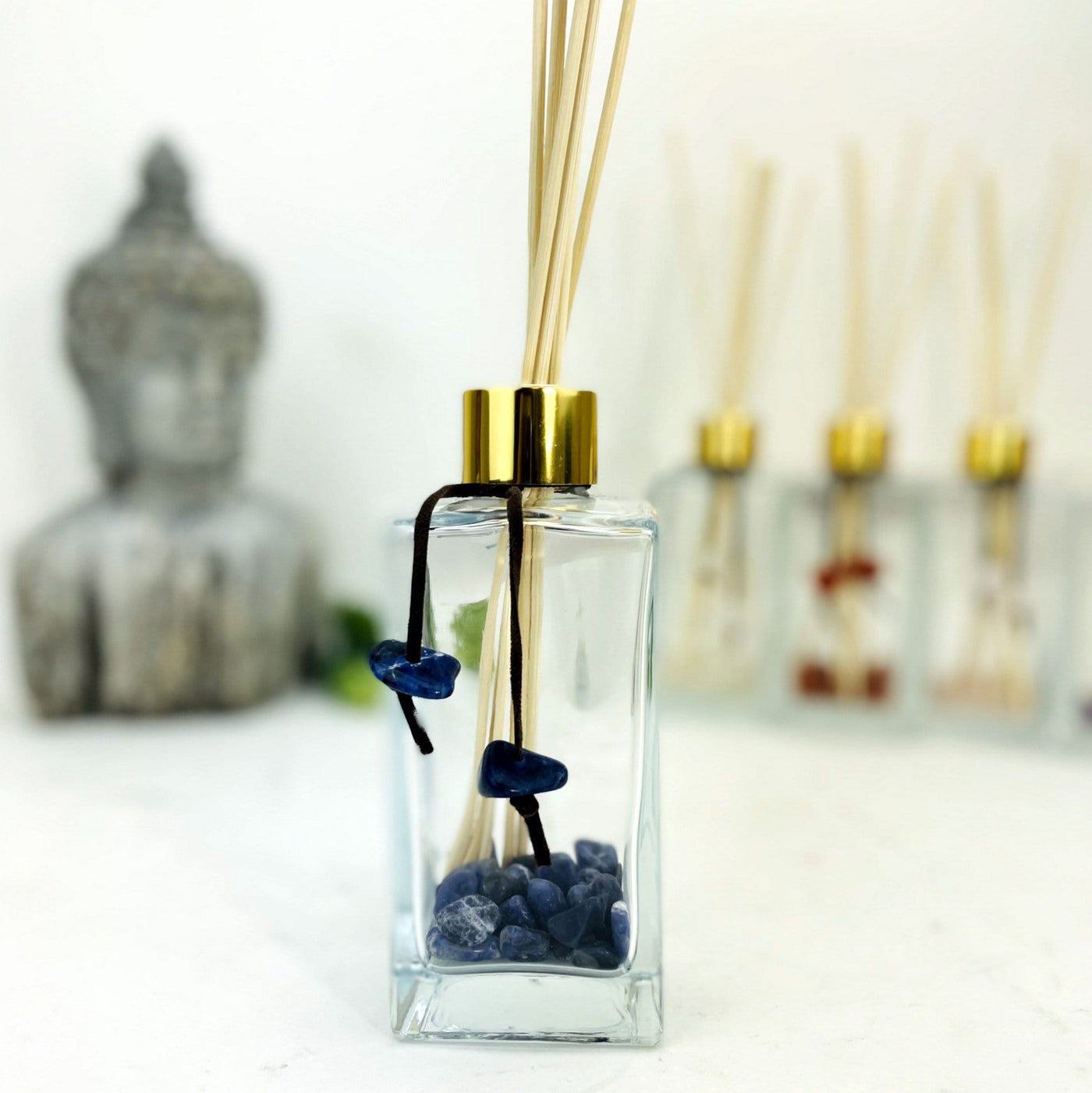Tumbled Stone Diffuser Bottle--front view shot of glass bottle with sodalite stone on string.