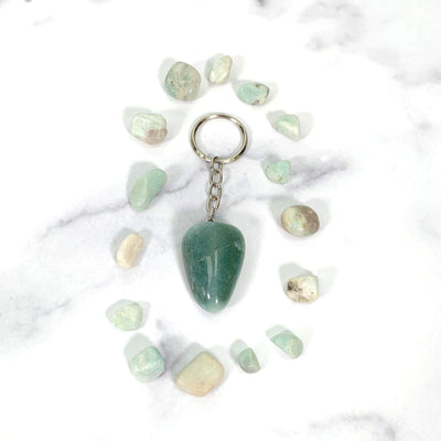 green quartz keychain on a table