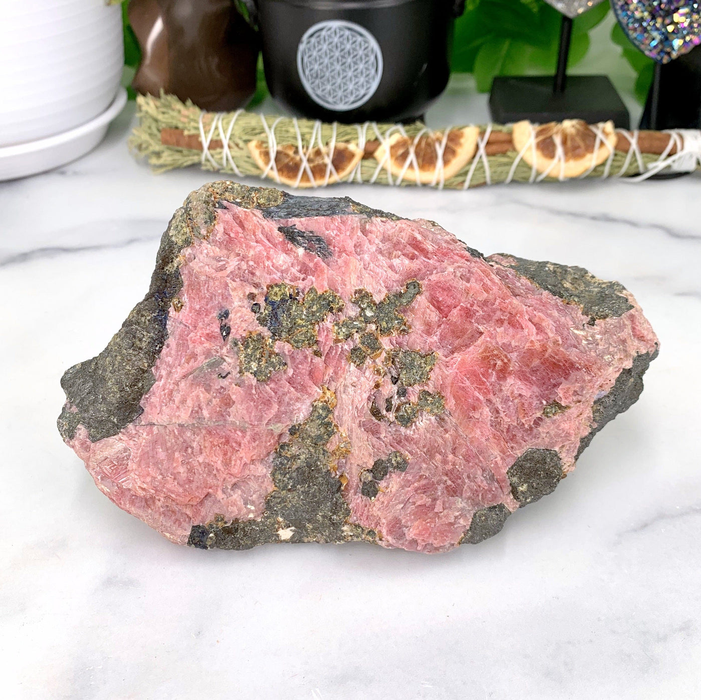 rhodonite stone on marble background