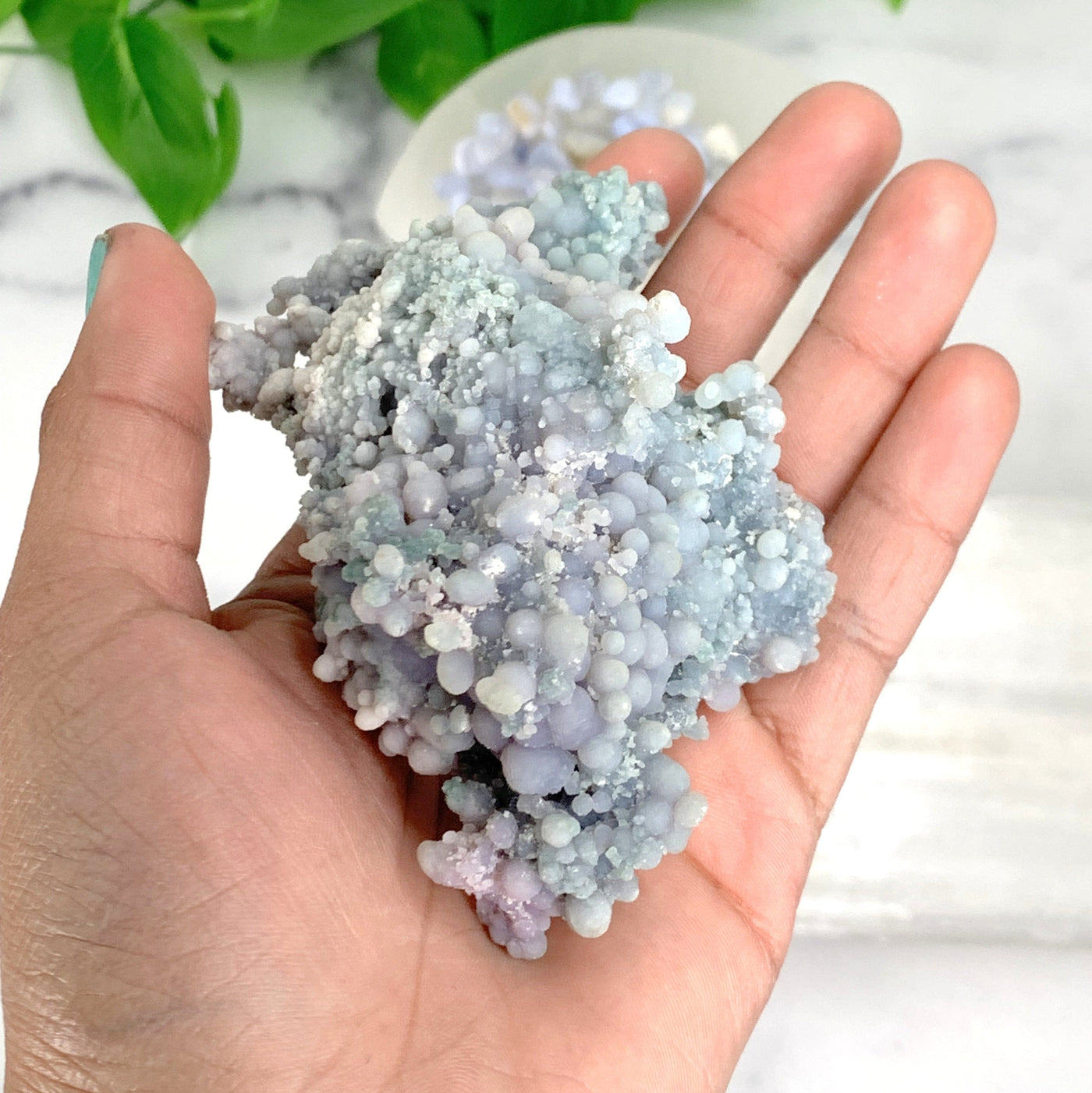 hand holding up Grape Agate Mineral Cluster