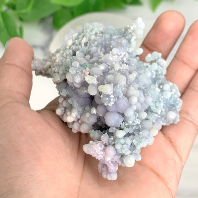 hand holding up Grape Agate Mineral Cluster