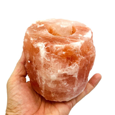 1 hole Himalayan Salt Candle Holder in a hand for size reference