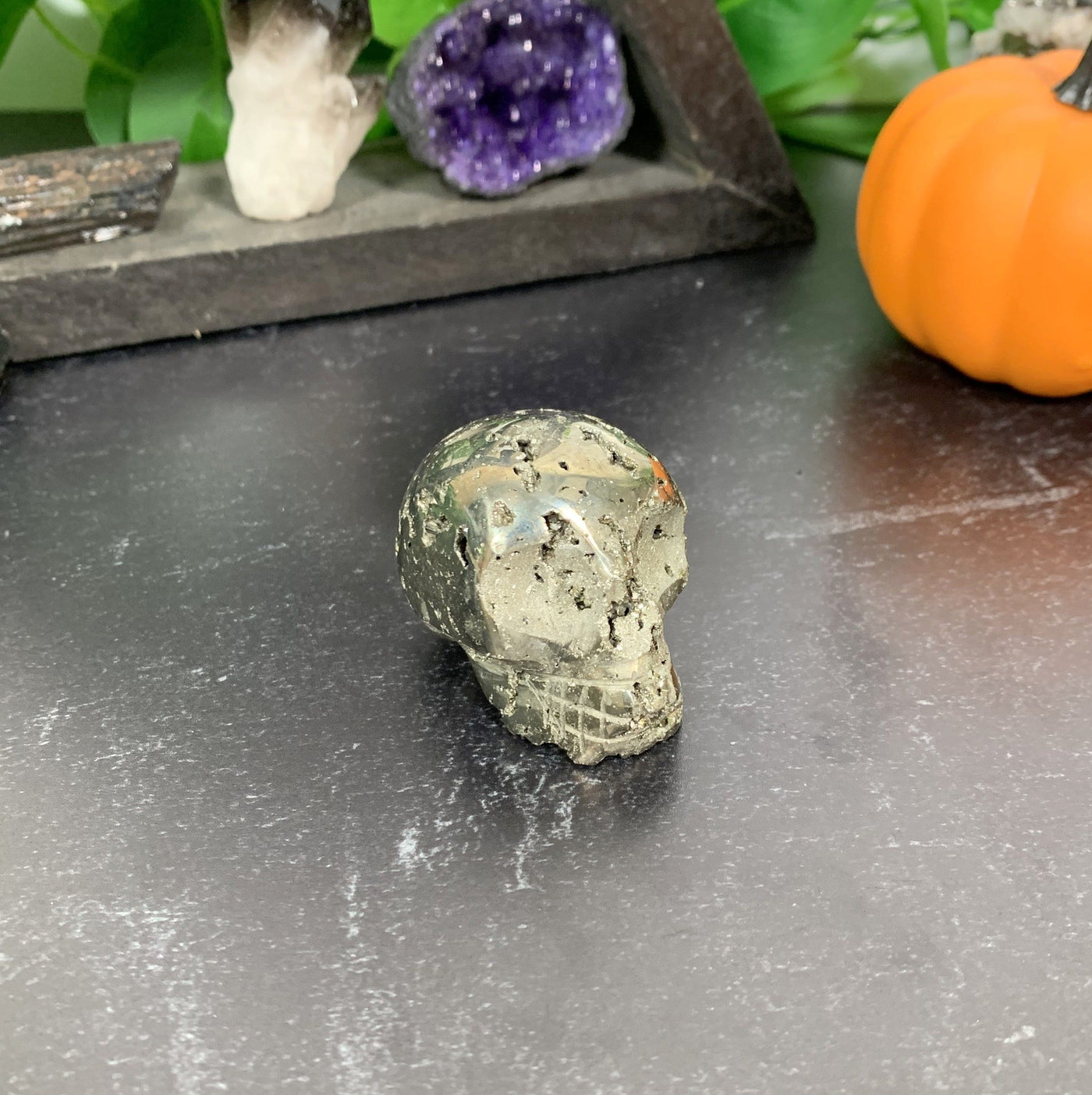 Pyrite Skull with decorations in the background