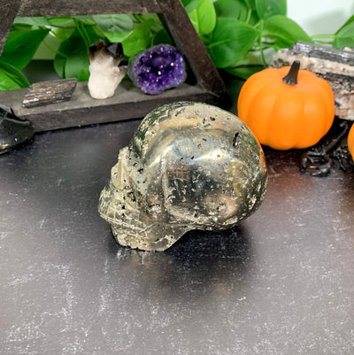 side view of Pyrite Skull with decorations in the background