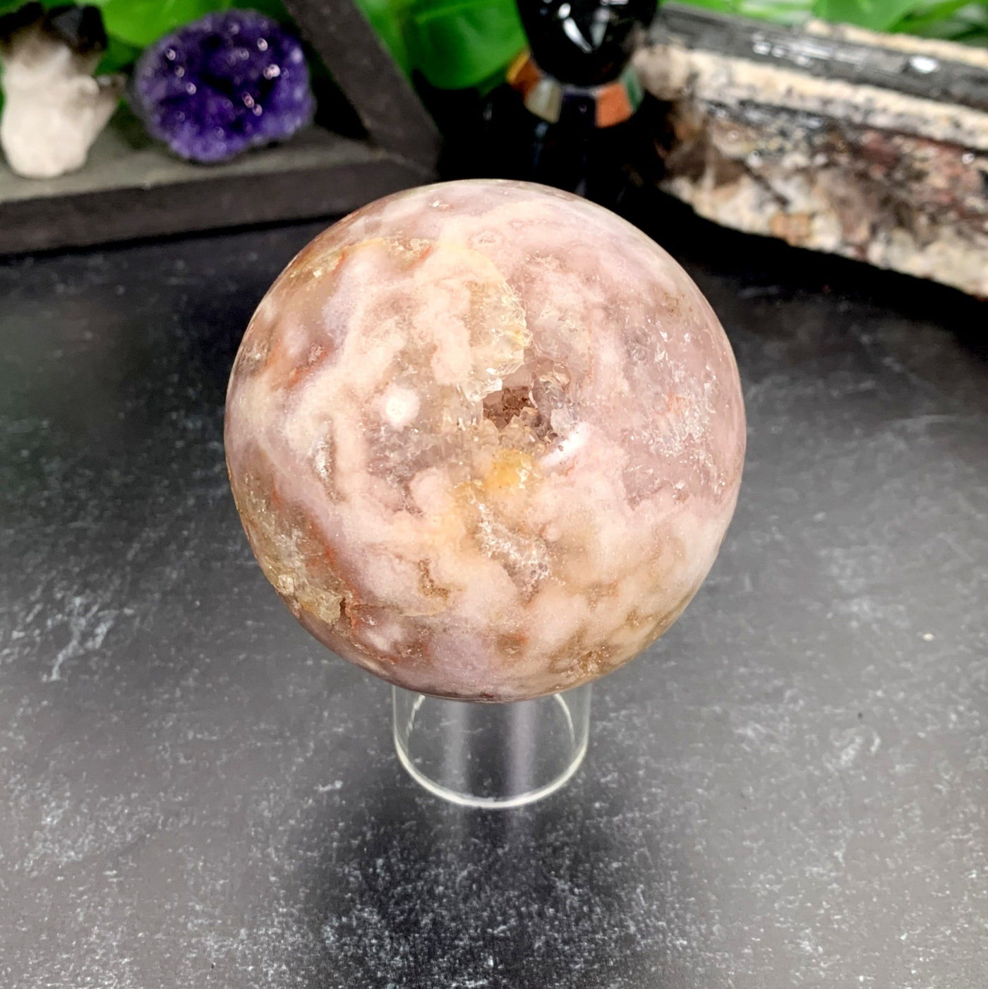 Pink Amethyst Druzy Sphere with decorations in the background