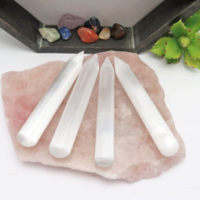 four selenite wand points on display for possible variations