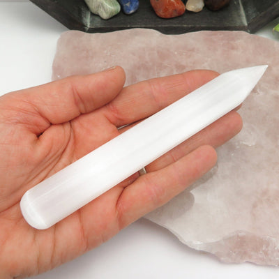 selenite wand point in hand for size reference 