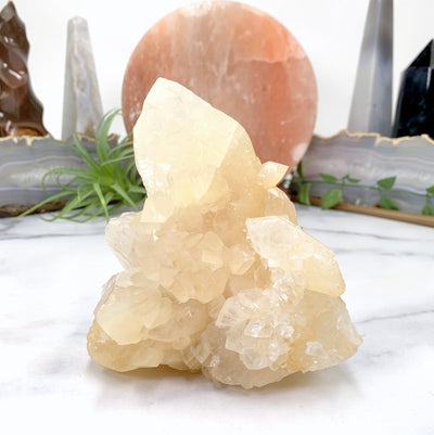 side view of calcite cluster with marble background