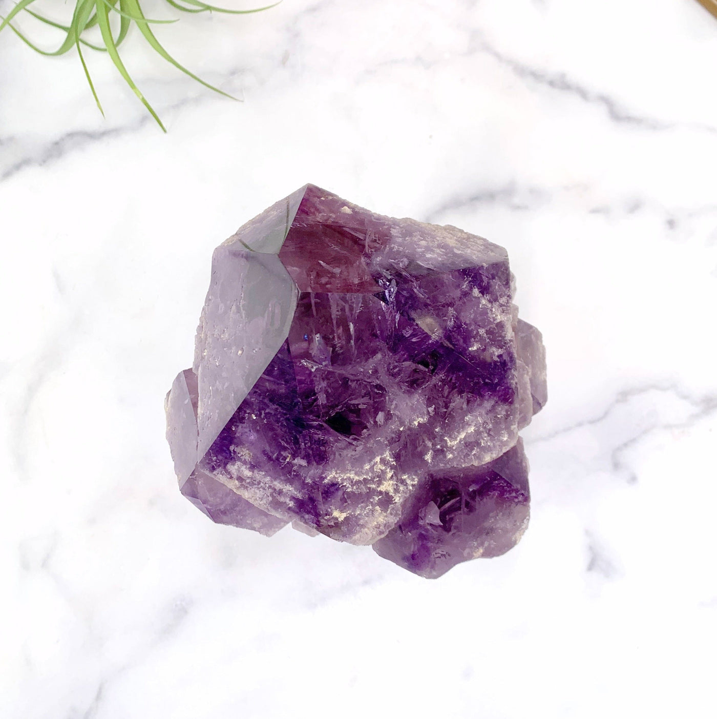birds eye view of amethyst point on marble background