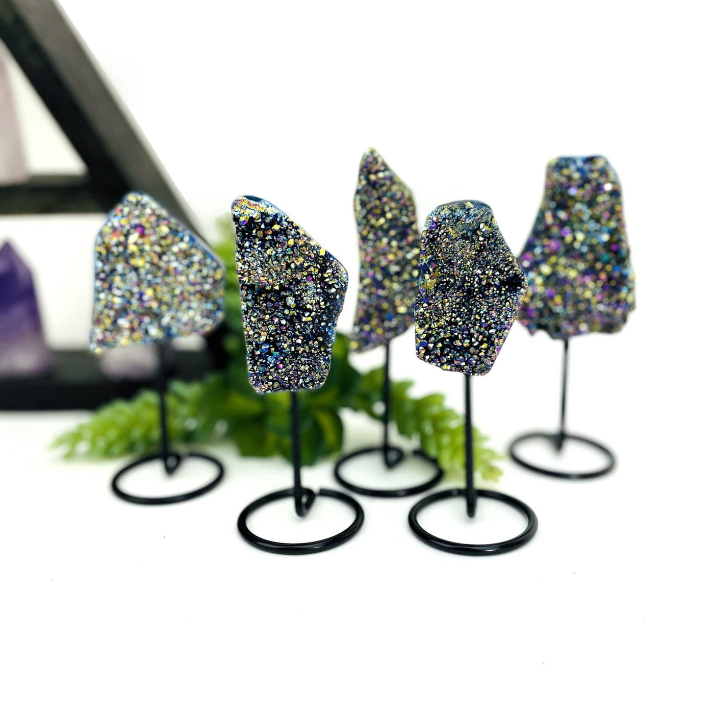 multiple titanium druzy clusters displayed to show the differences in the sizes