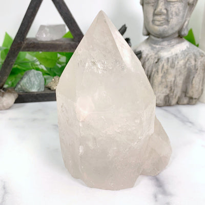 Crystal Quartz Point with decorations in the background