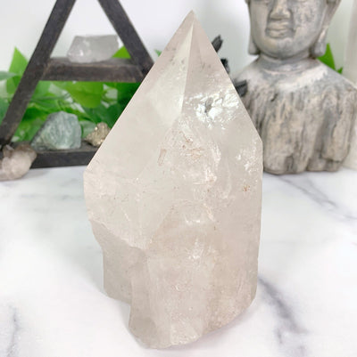 side view of Crystal Quartz Point with decorations in the background